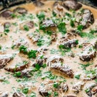 side view shot of creamy garlic mushrooms in a skillet