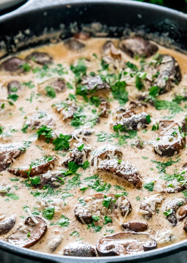 side view shot of creamy garlic mushrooms in a skillet