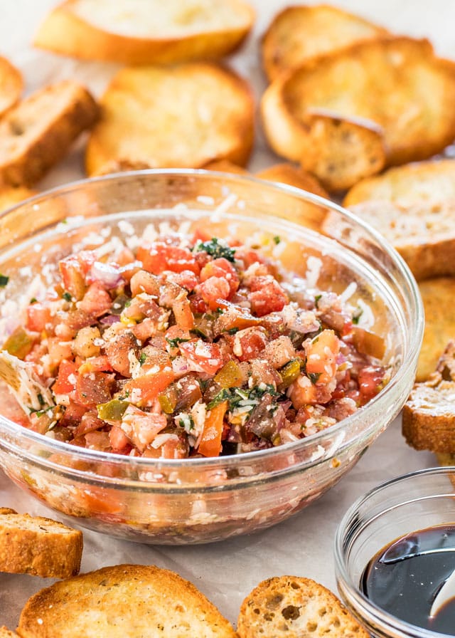 bruschetta in a bowl with toasted bread around it