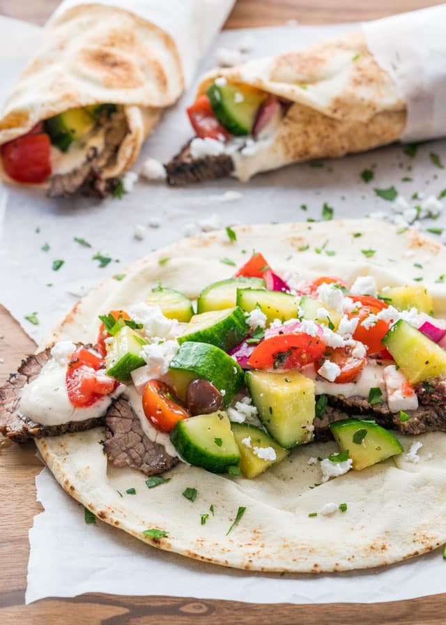 beef brisket gyro unwrapped with greek salad on top