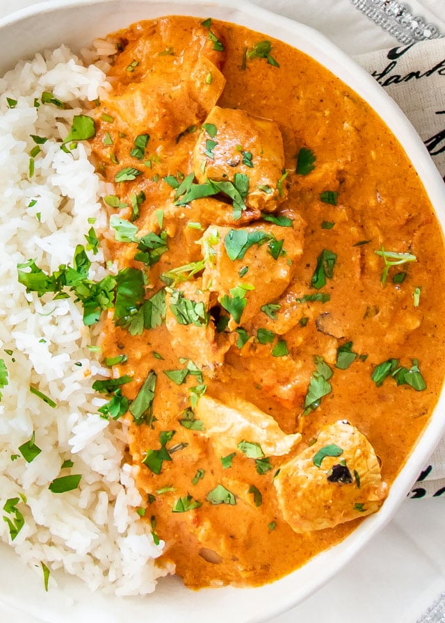 over head shot of Instant Pot Chicken Tikka Masala in a white plate with rice