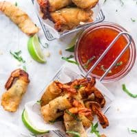 overhead shot of firecracker shrimp in two baskets with a side bowl of dipping sauce