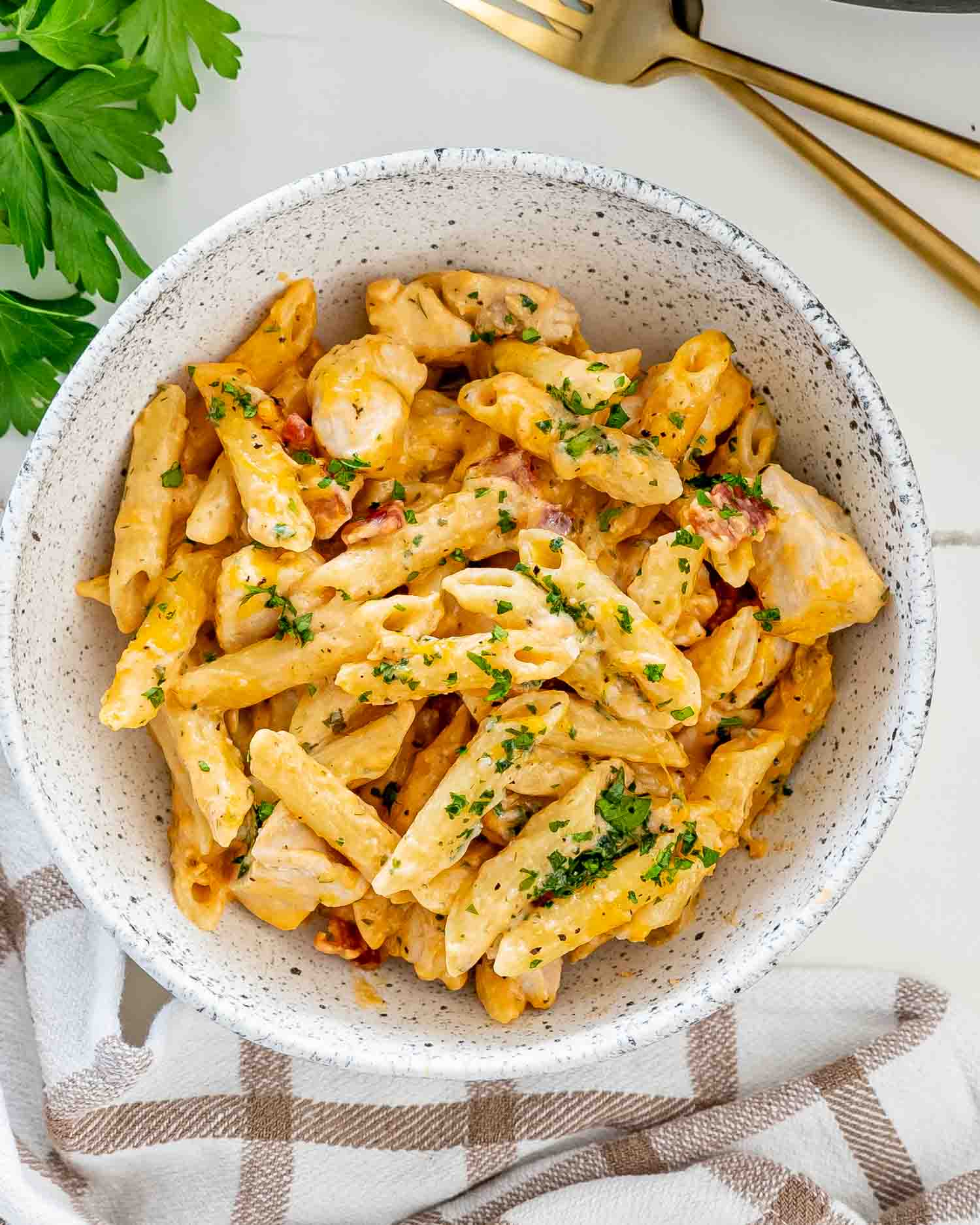 crack chicken penne in a bowl garnished with parsley.