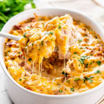 side view shot of a serving spoon lifting up a scoop of chicken bacon ranch casserole from the baking dish