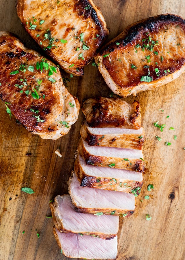 pork chops sliced on a cutting board
