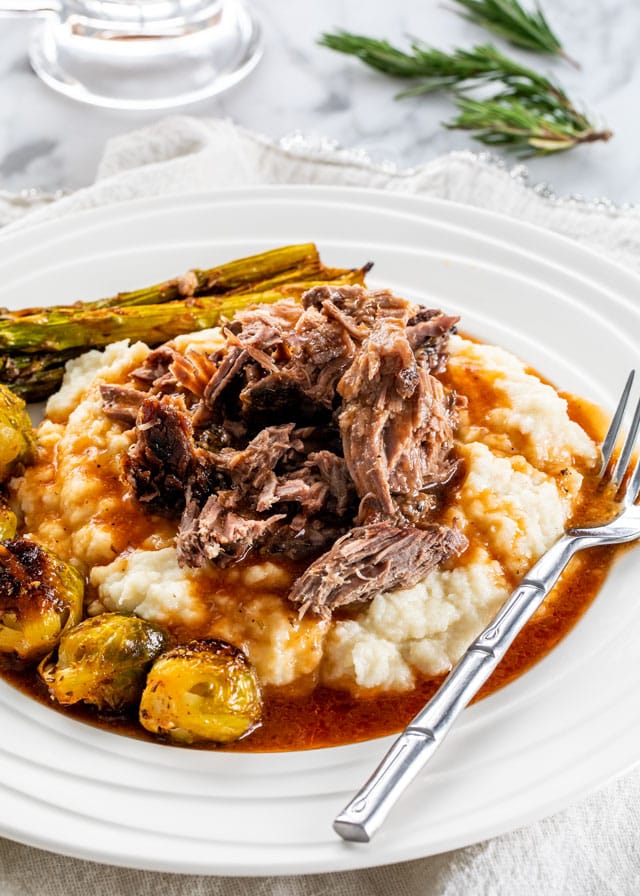 Slow Roast Leg of Lamb over a bed of mashed potatoes with gravy