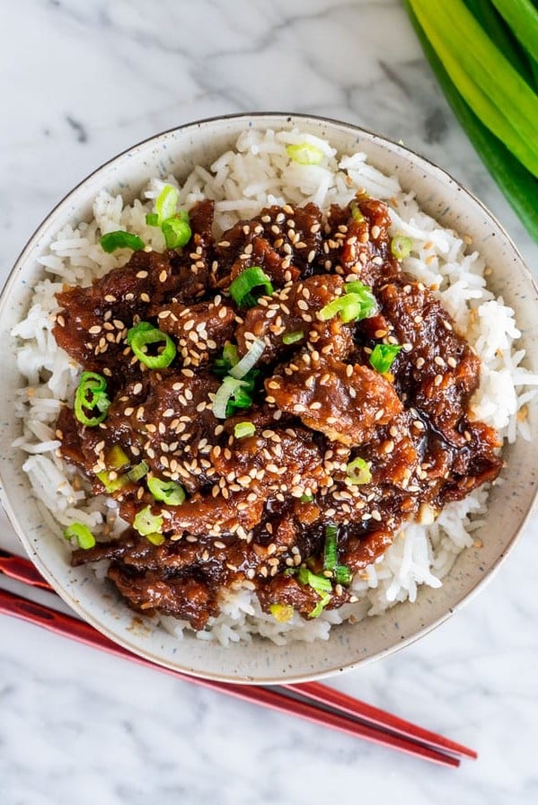 overhead shot of a bowl of rice topped with instant pot mongolian beef
