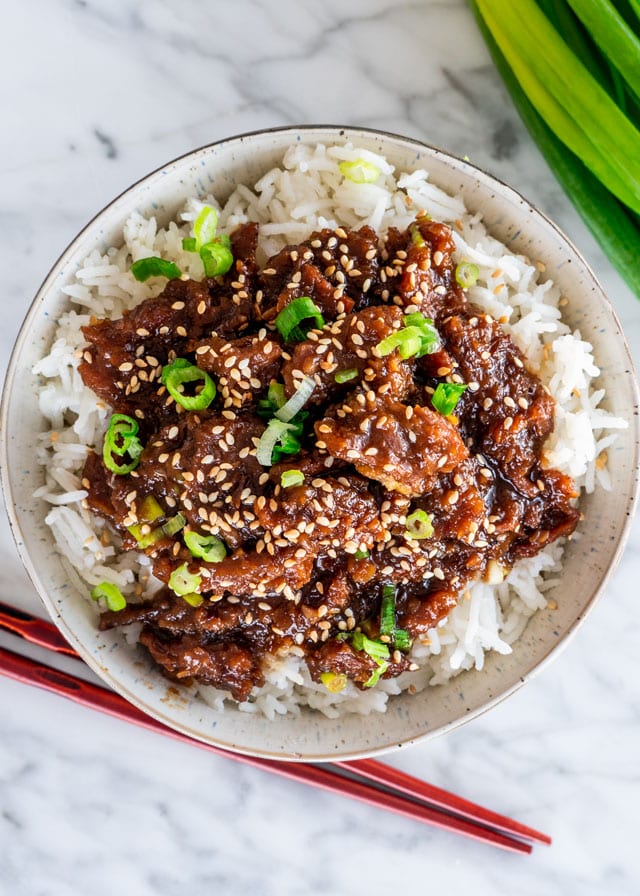 overhead shot of a bowl of rice topped with instant pot mongolian beef