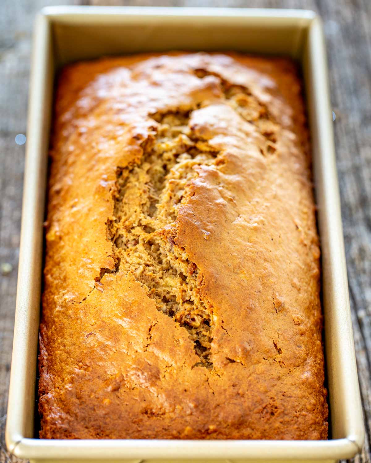 banana nut bread in a loaf pan fresh out of the oven.
