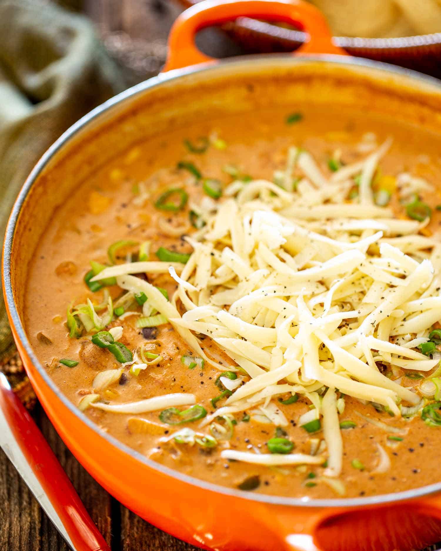 freshly made cheesy chicken enchilada soup in a dutch oven.