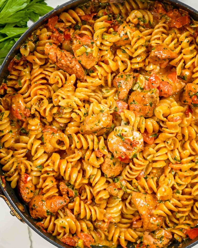 freshly made creamy tomato chicken pasta in a skillet.