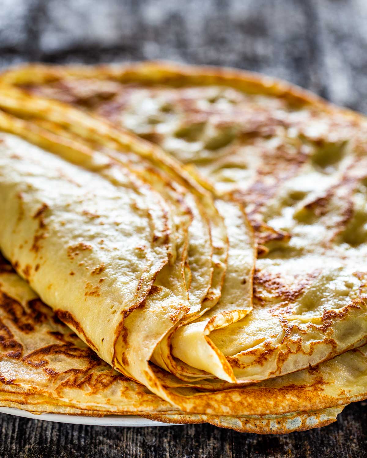 a bunch of crepes folded on a plate.