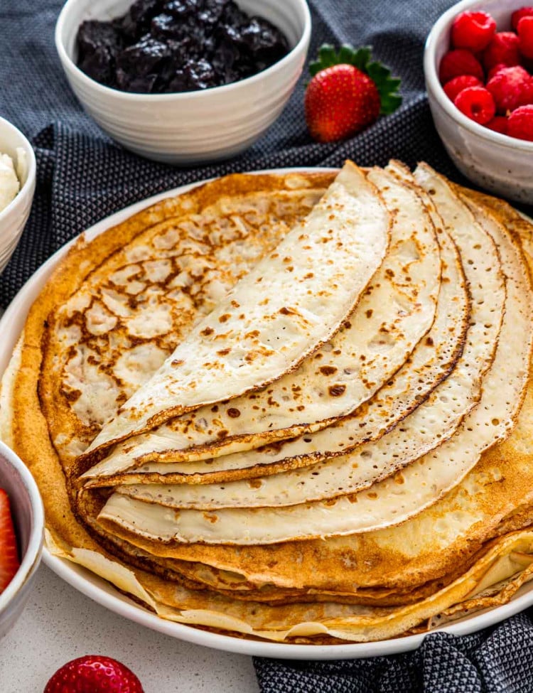 a bunch of crepes folded on a plate.