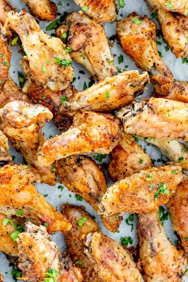 crispy baked salt and pepper wings garnished with parsley.