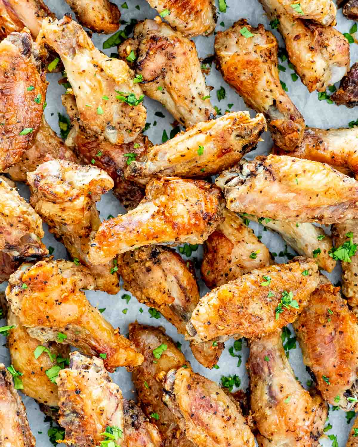 crispy baked salt and pepper wings garnished with parsley.