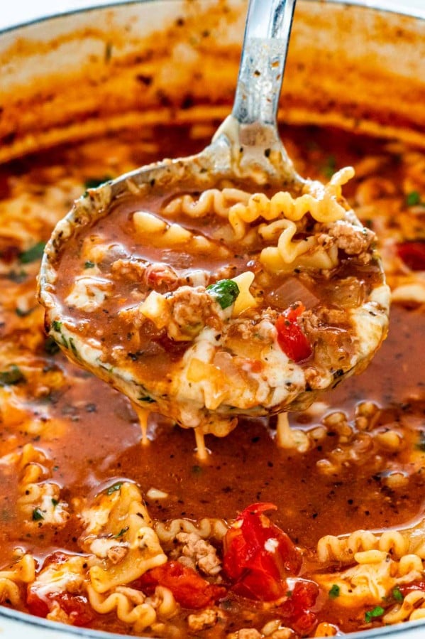 lasagna soup in a dutch oven with a ladle inside.