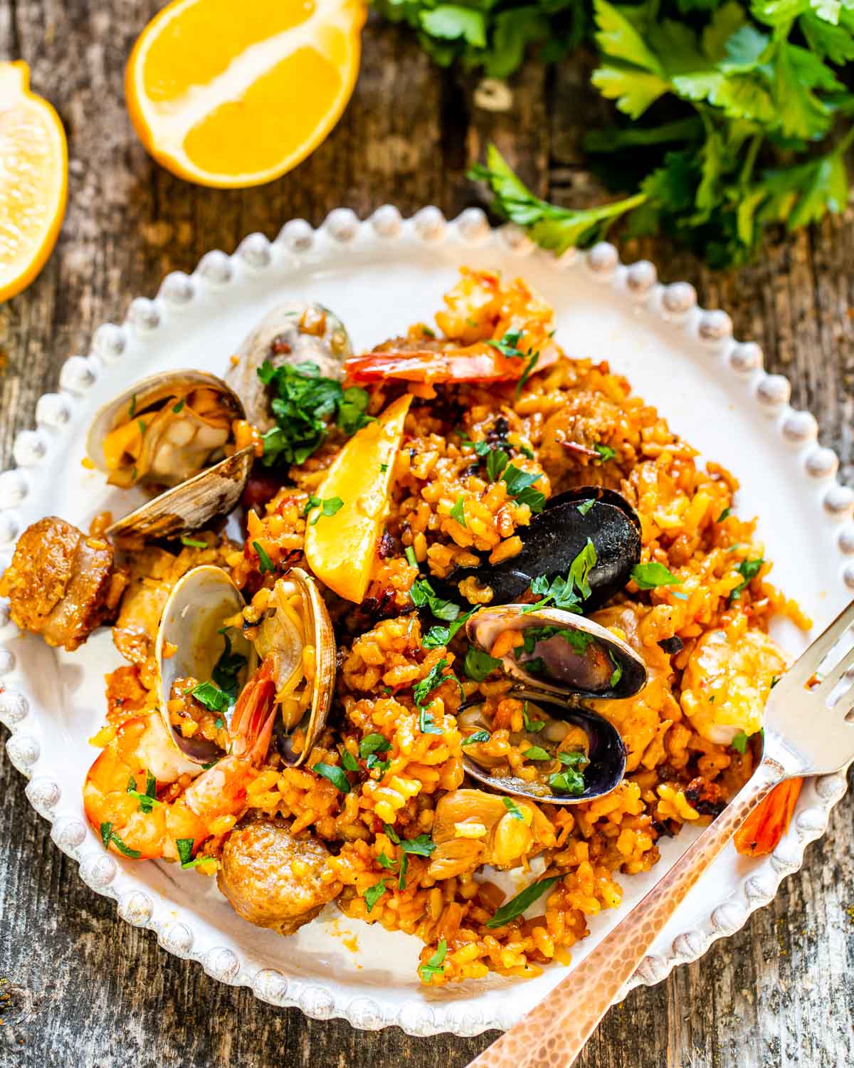 a serving of paella in a white plate.