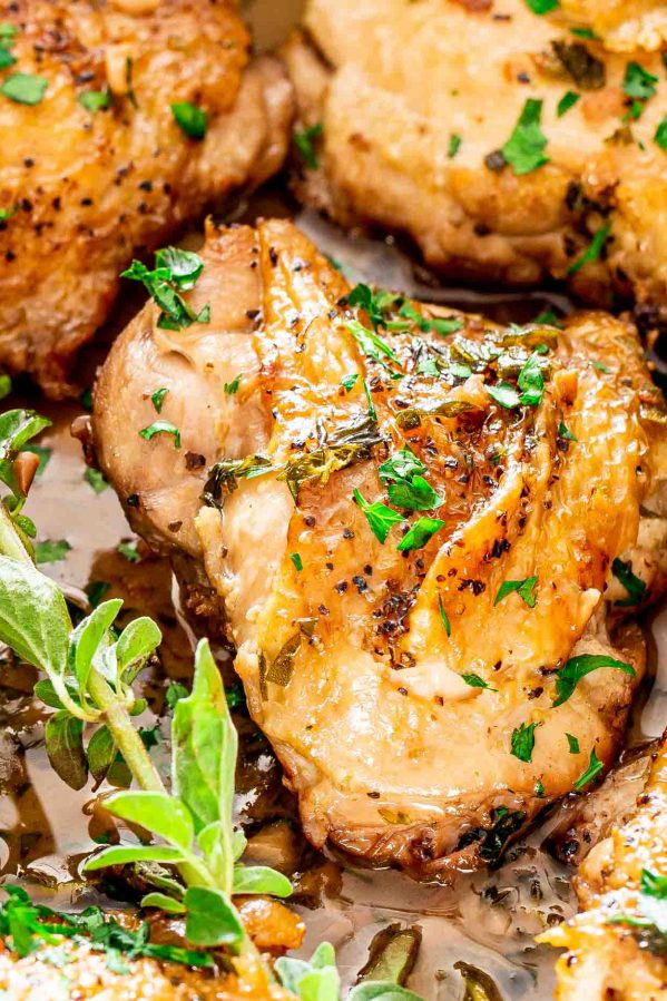 chicken in garlic and herb sauce in a skillet.
