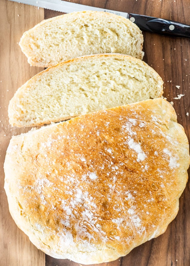 Fast and Easy No Knead Bread sliced on a cutting board