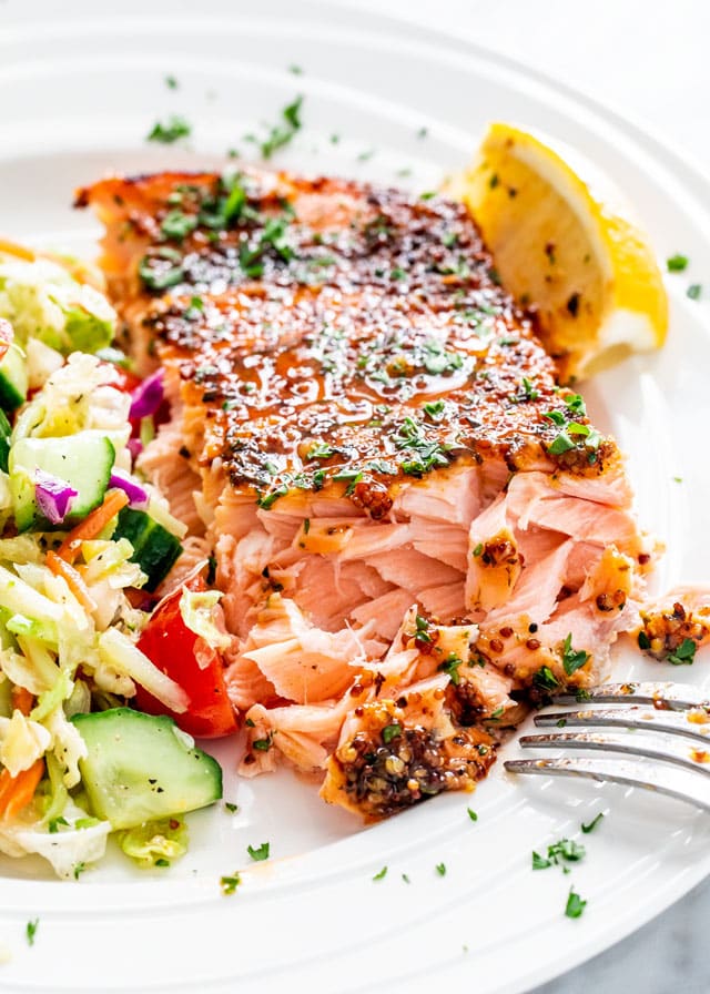 Honey Mustard Salmon piece on a white plate with salad