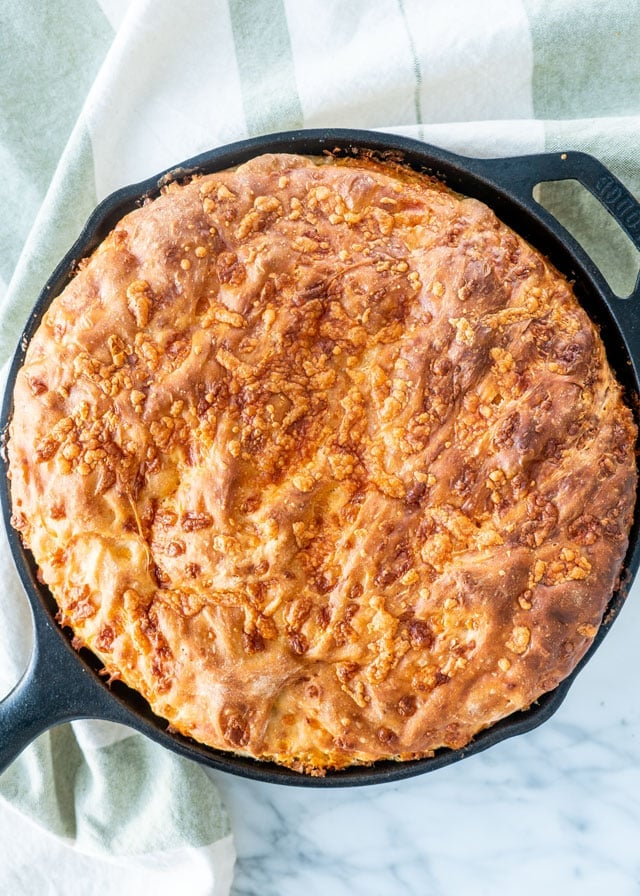 overhead shot of a no knead skillet bread topped with cheese