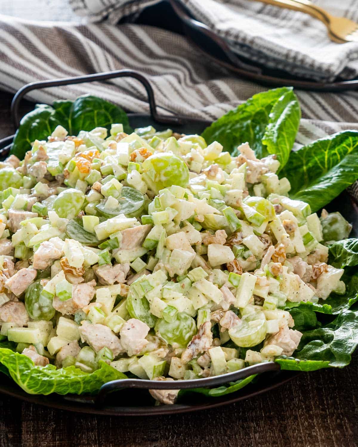 freshly made waldorf salad on a bed of lettuce.