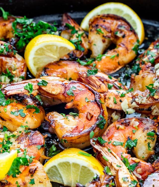 side view shot of honey garlic shrimp in a skillet