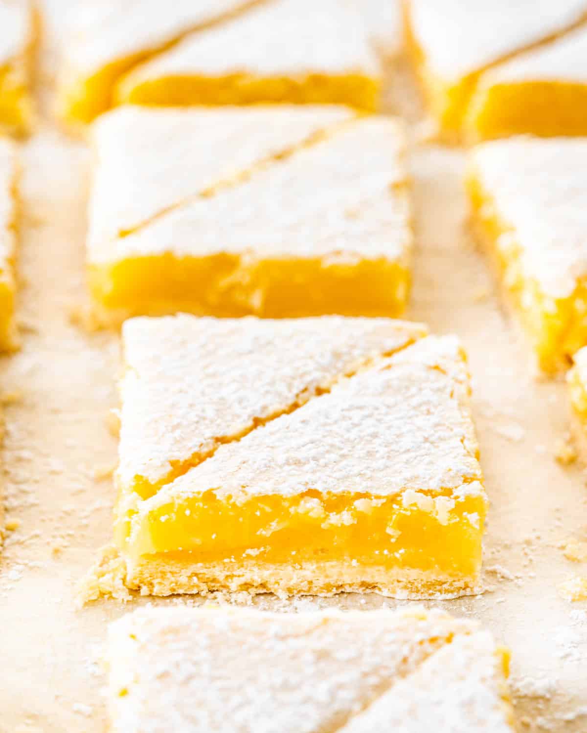 lemon bars cut into triangles and dusted with icing sugar.