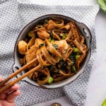 a serving of pad see ew in a bowl with chop sticks.