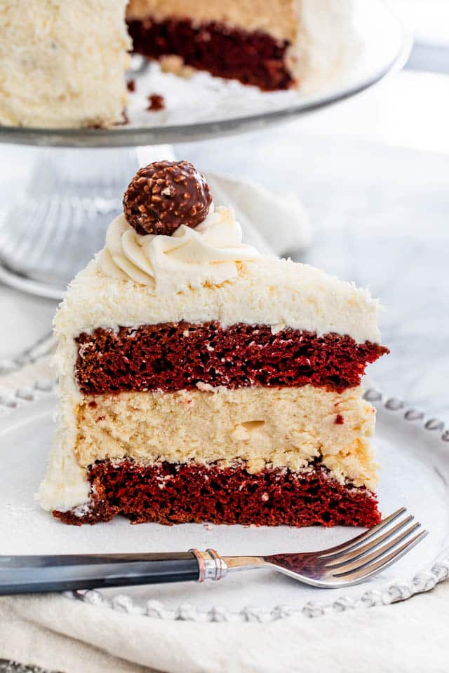 Red Velvet Cheesecake Cake slice on a white plate
