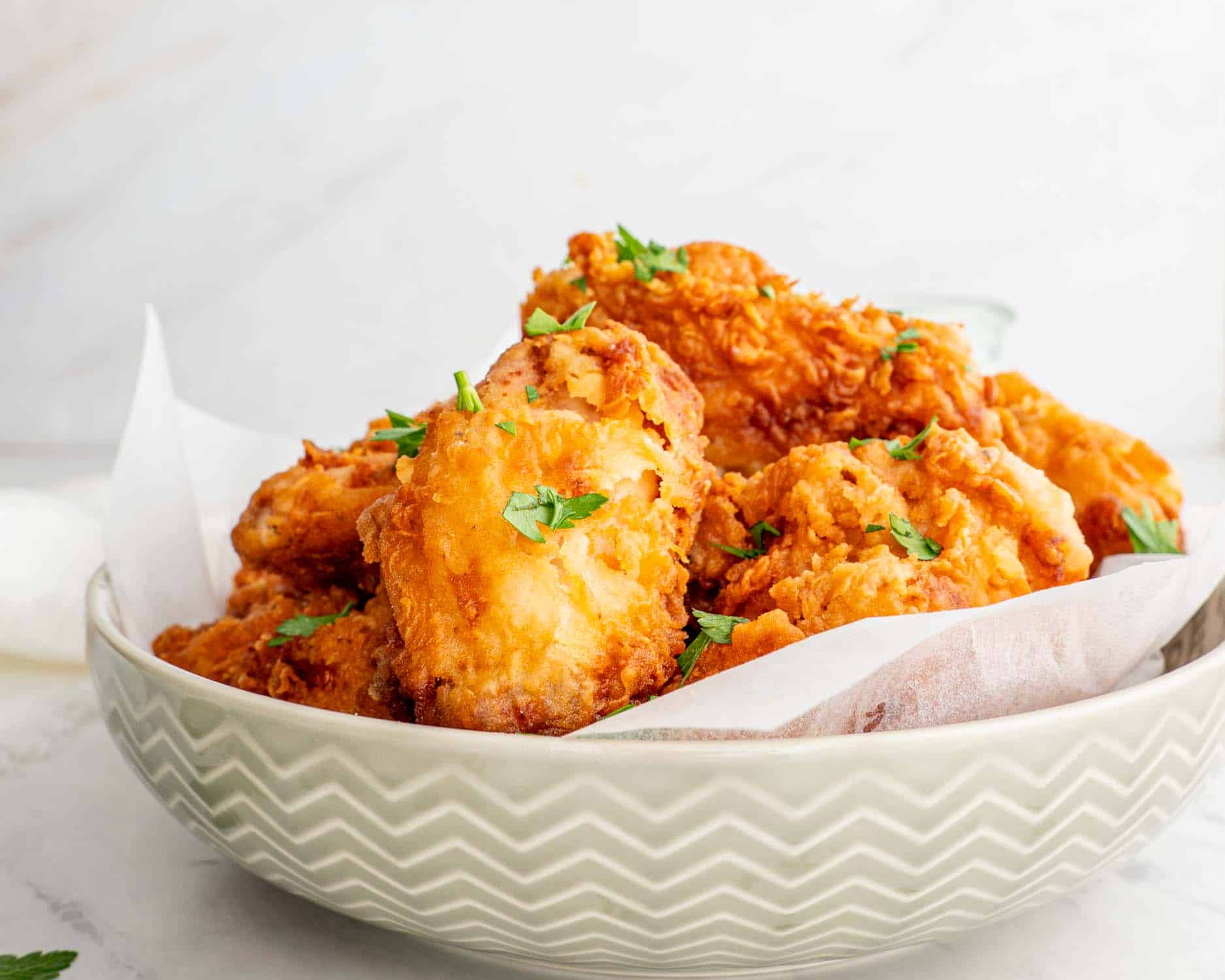 a bowl with crispy and delicious buttermilk fried chicken.