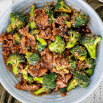 beef and broccoli that was made in the instant pot in a blue bowl.