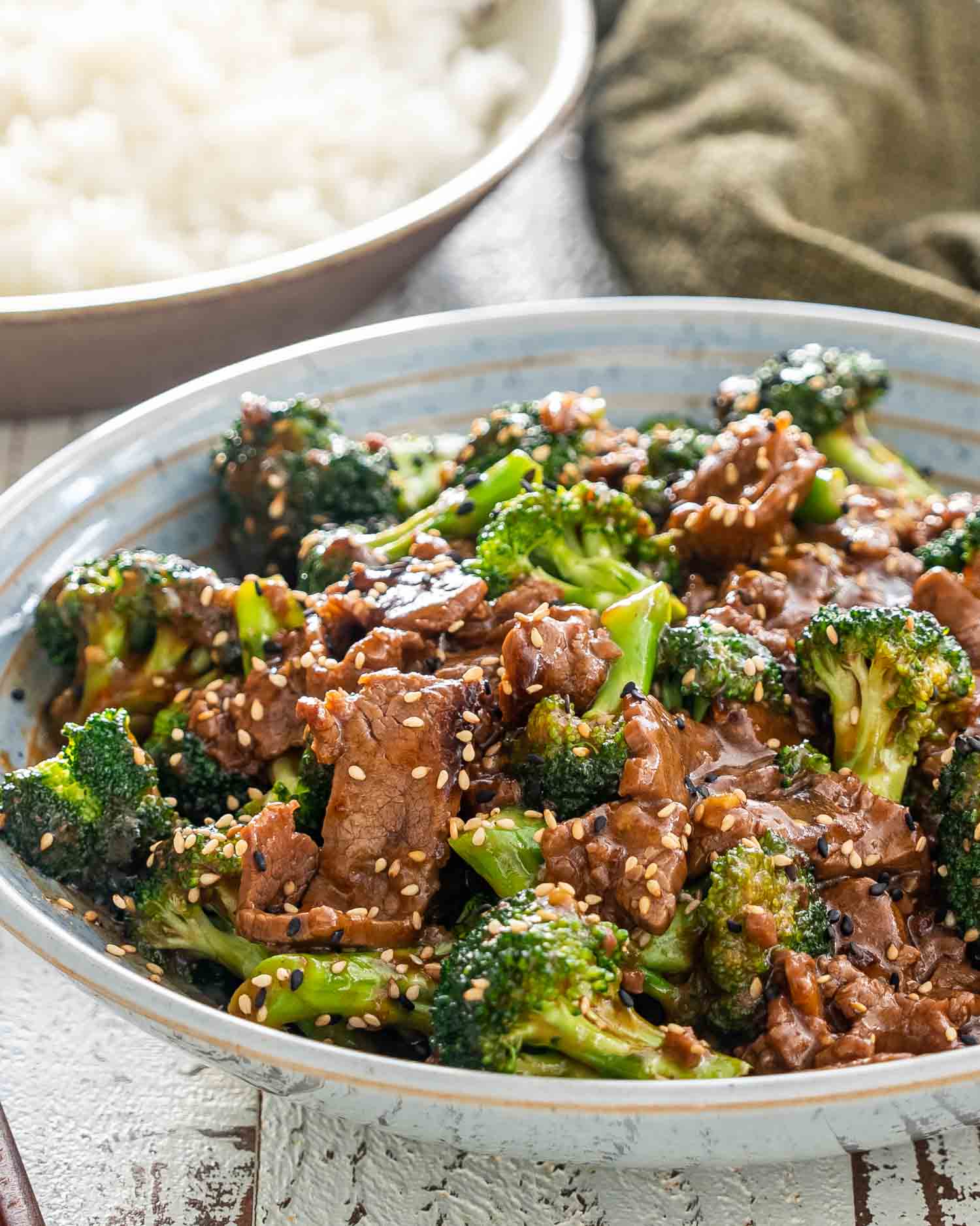 beef and broccoli that was made in the instant pot in a blue bowl.