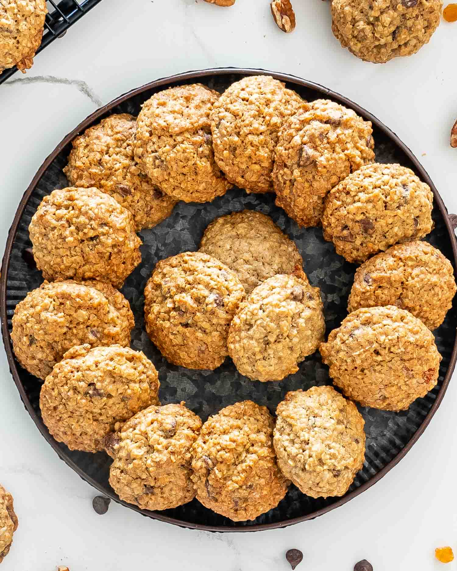 a metal plate full of freshly baked oatmeal cookies.