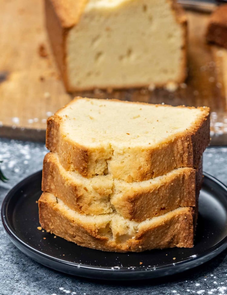a few slices of pound cake on a black plate.