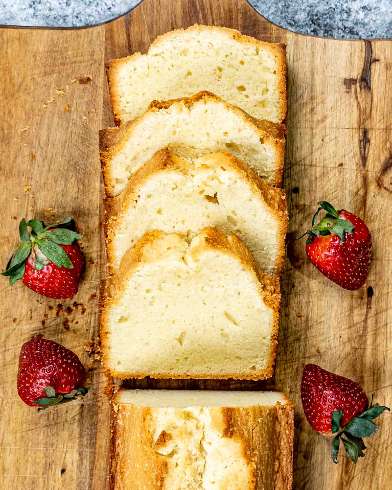 a few slices of pound cake on a cutting board.