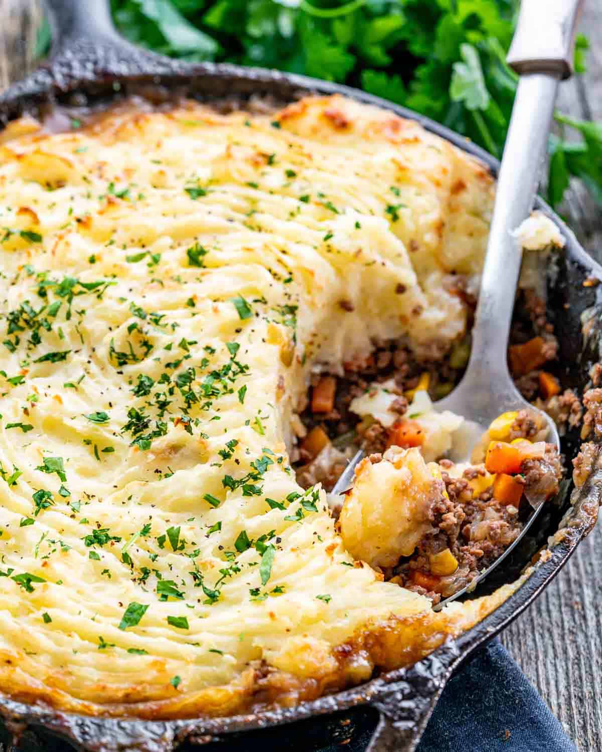 skillet shepherd's pie with a serving spoon inside the skillet.