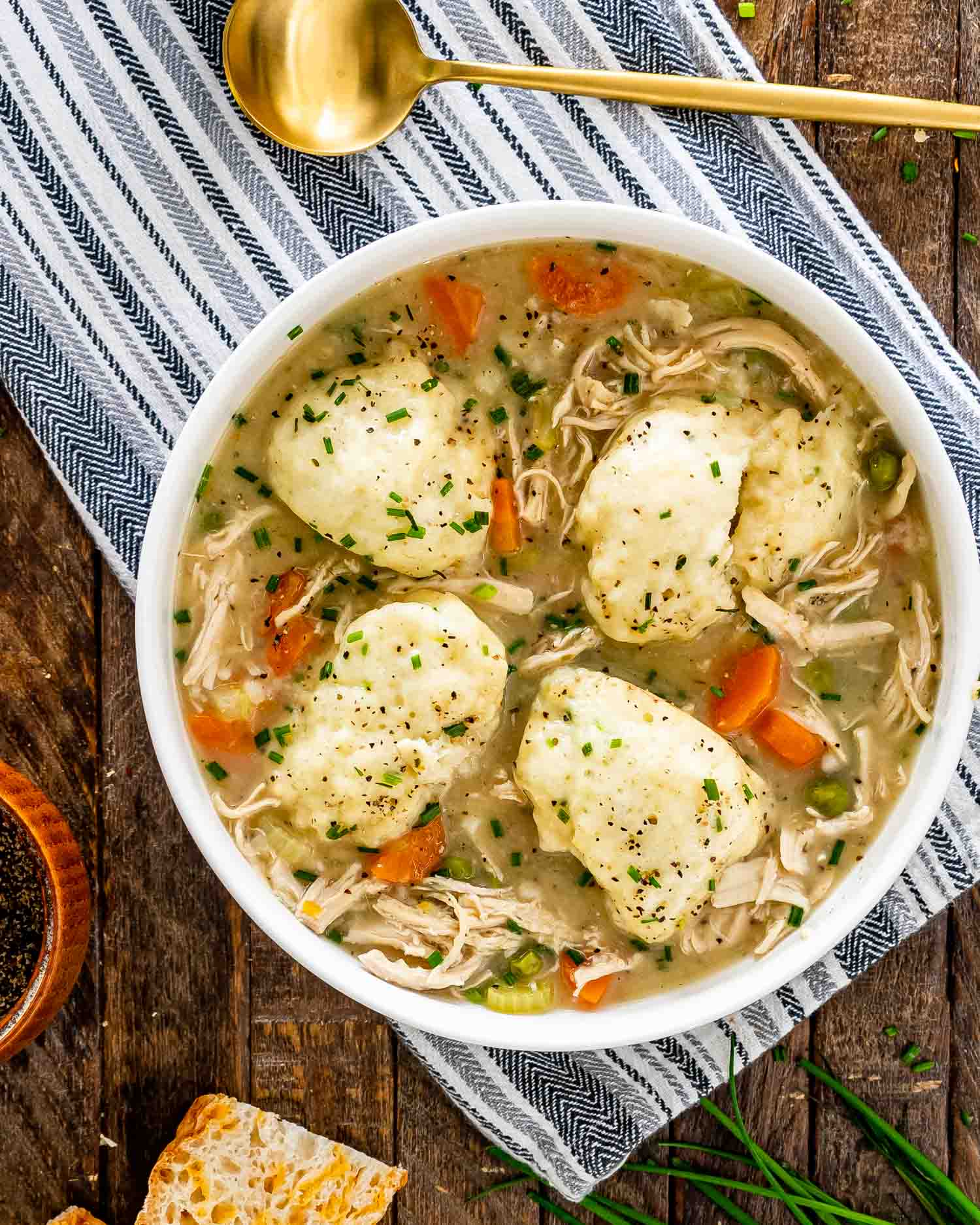 chicken and dumplings in a white bowl.