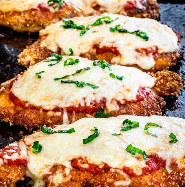 side view shot of chicken parmesan on a baking tray
