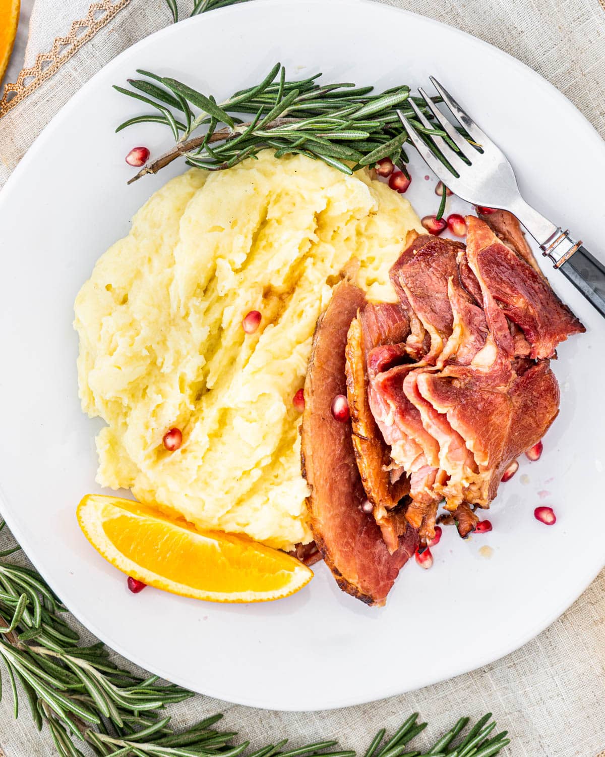 overhead shot of some ham slices next to mashed potatoes