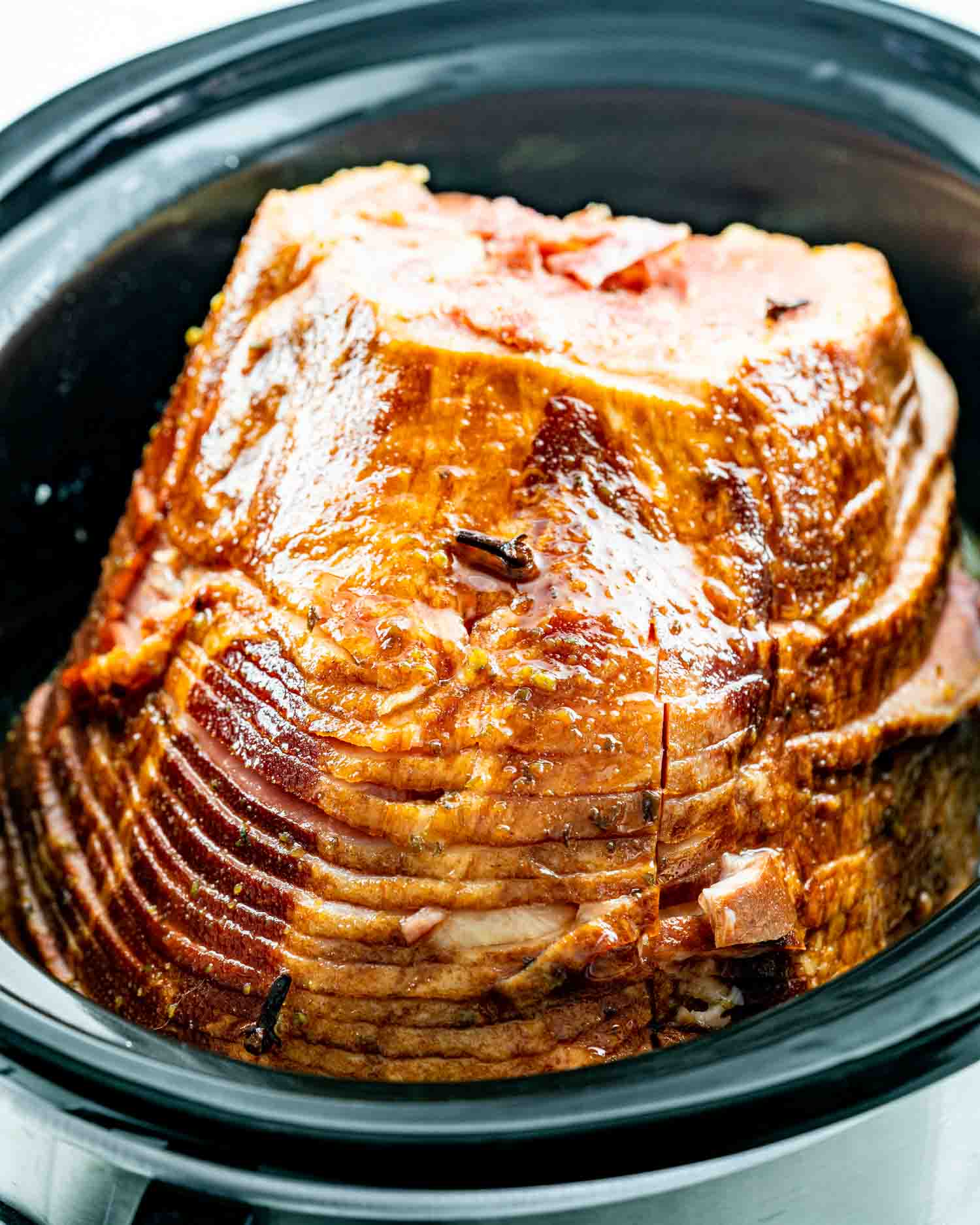a ham in a crockpot with honey mustard glazed ham.