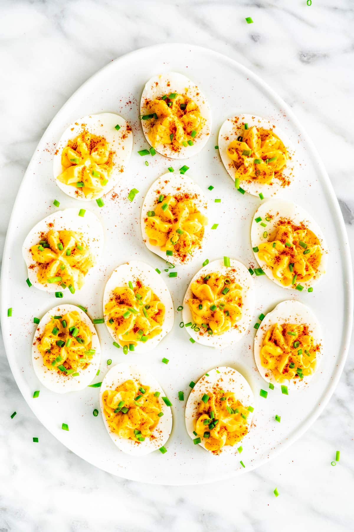 overhead shot of an egg shaped plate covered in deviled eggs