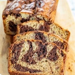 sliced marbled chocolate banana bread on a cutting board.