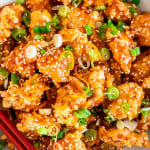 overhead close up shot of orange chicken in a bowl