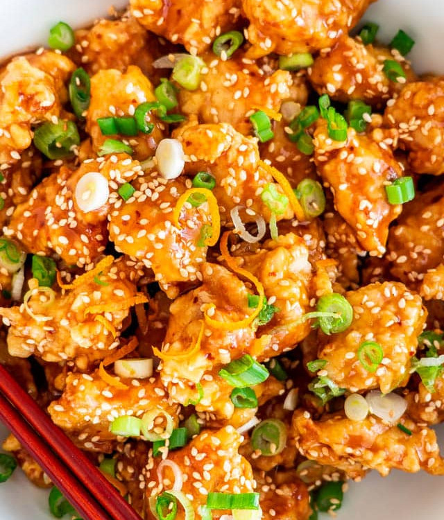 overhead close up shot of orange chicken in a bowl