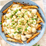 overhead shot of poutine with a ton of cheese curds and gravy on top.