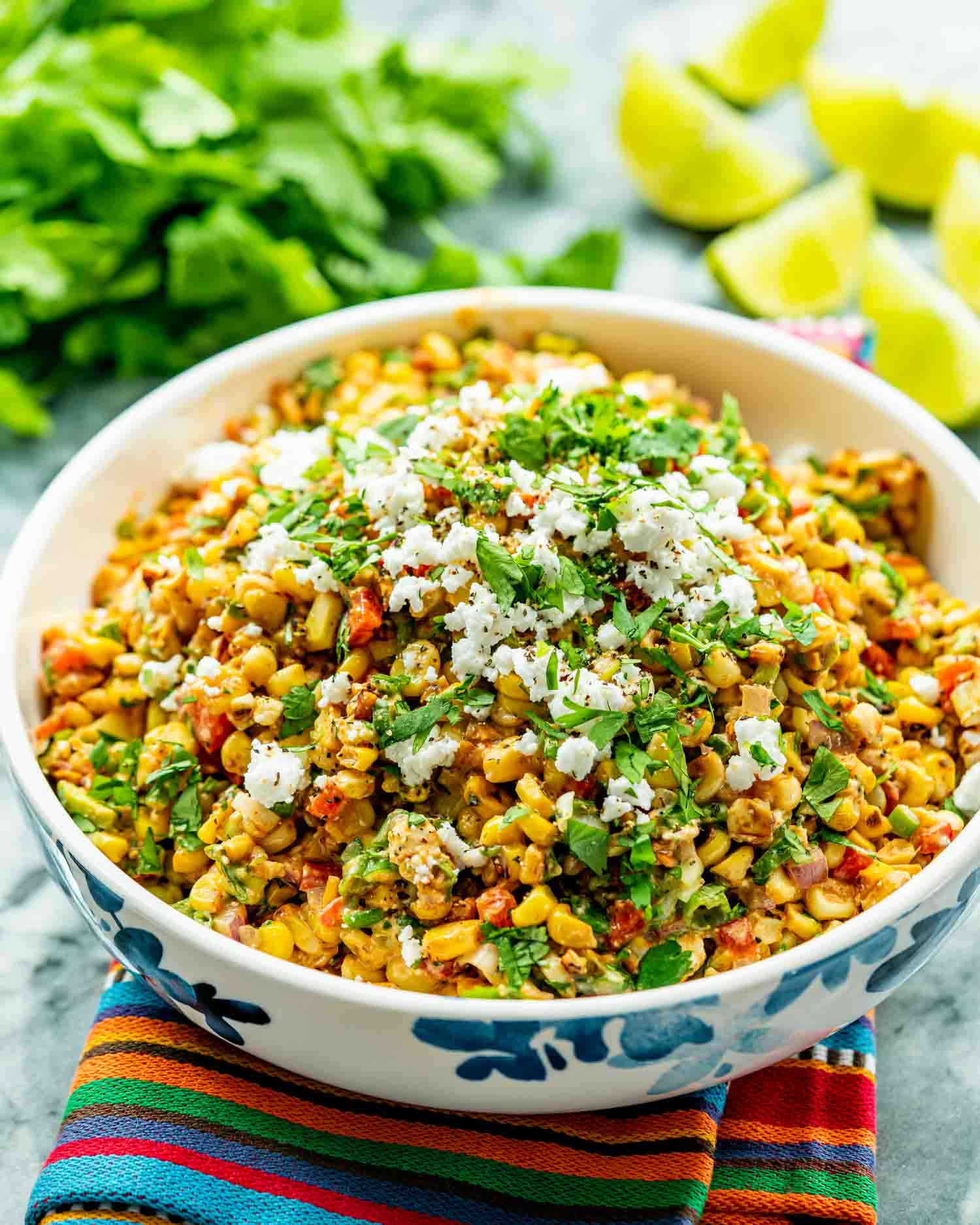 mexican street corn salad in a bowl garnished with cilantro and cotija cheese.