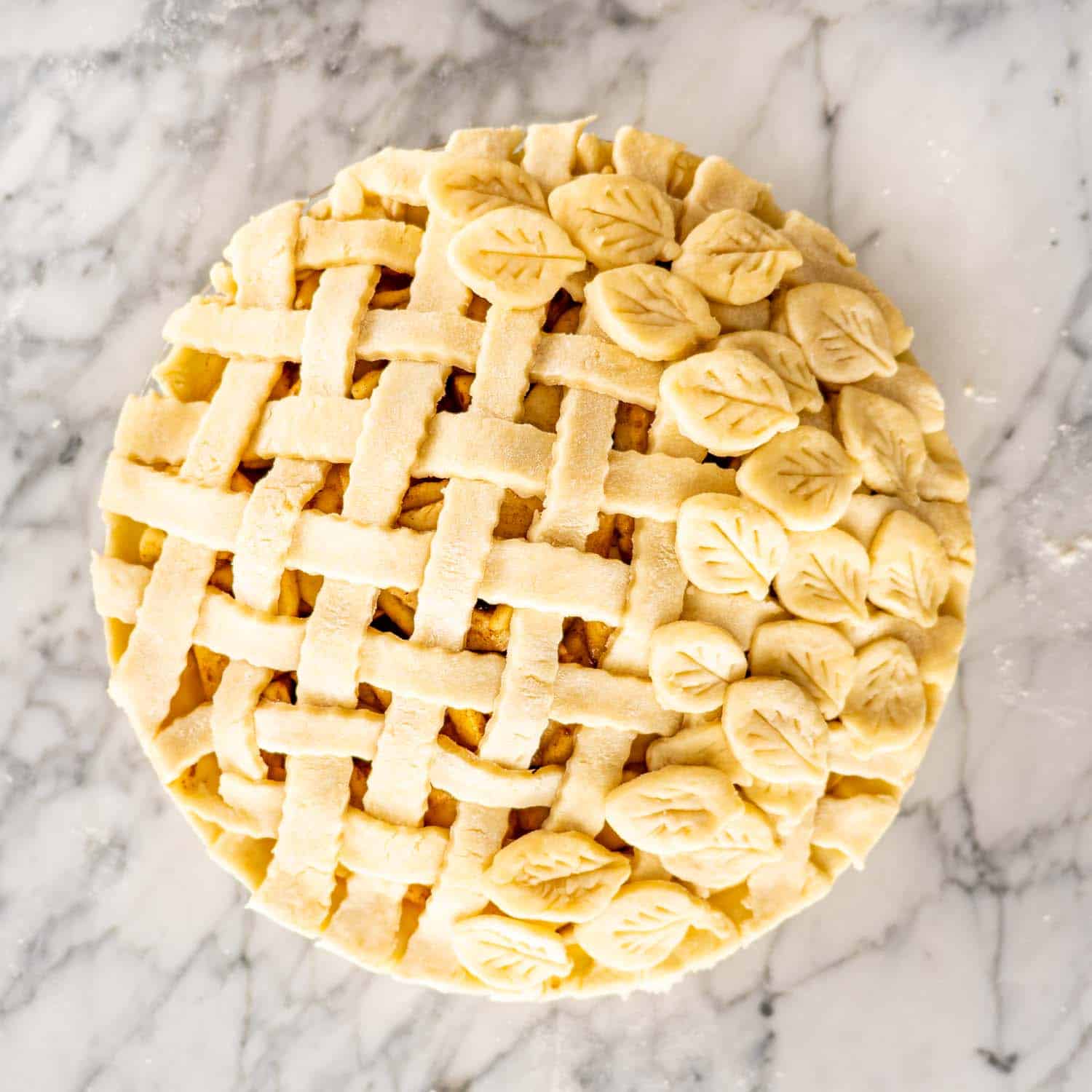 beautiful unbaked apple pie with lattice crust.
