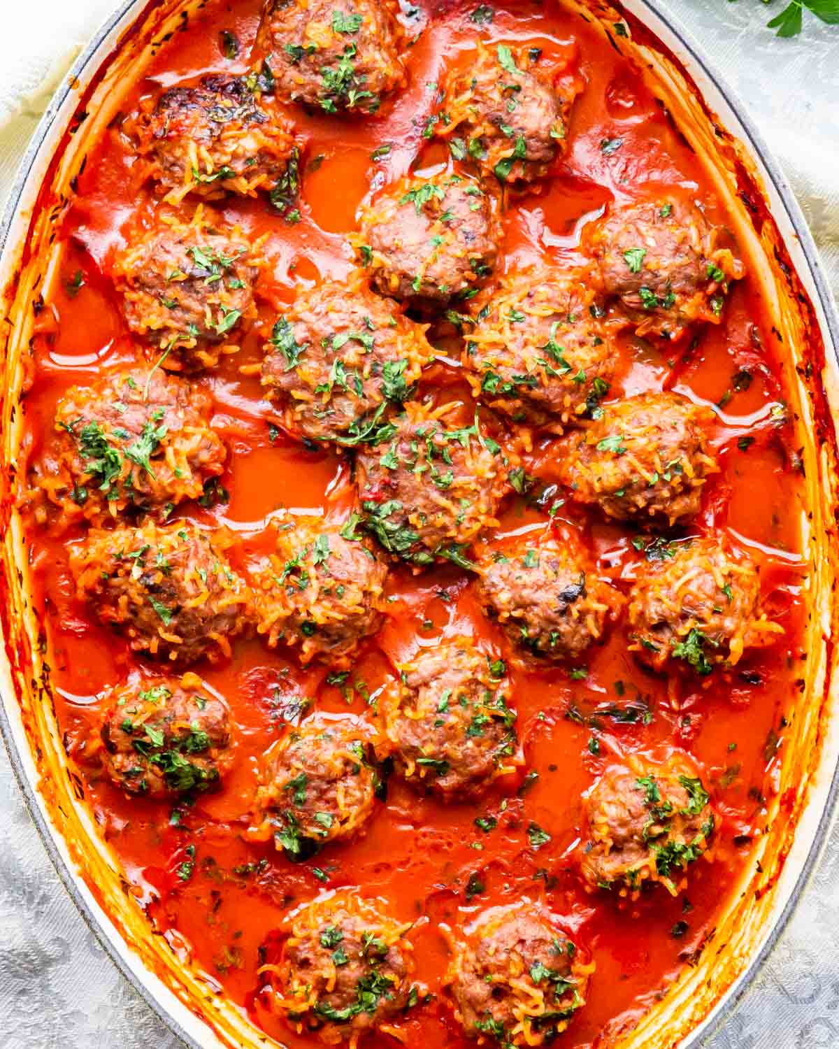overhead of finished porcupine meatballs in a baking dish