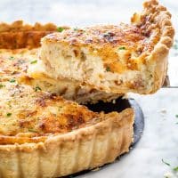 side view shot of a slice of quiche being lifted from the quiche lorraine